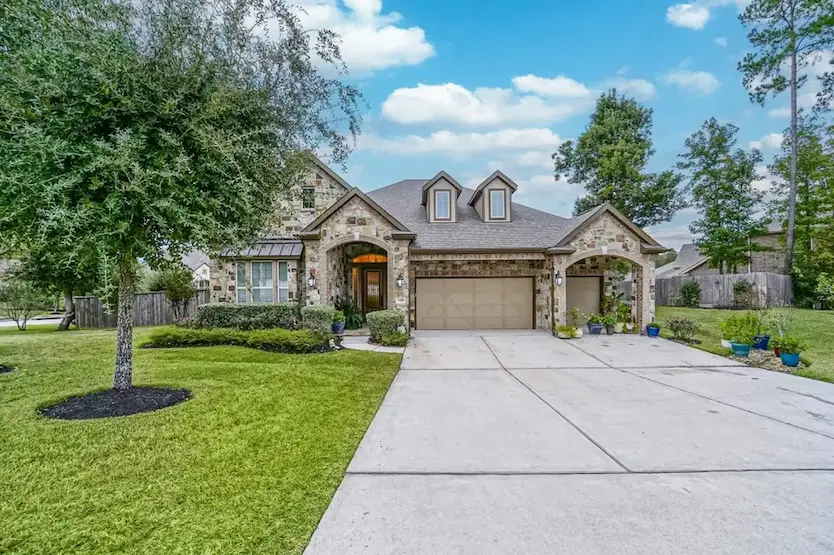 A charming residence with an expansive driveway and a garage
