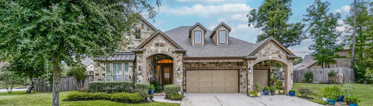 spacious home featuring a large garage and a wide driveway