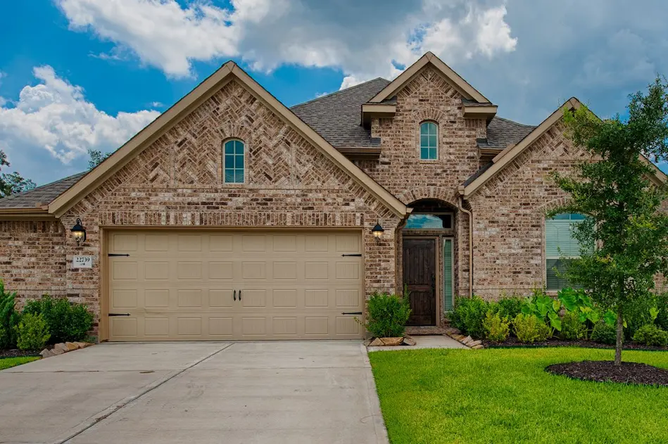 A stunning home featuring a spacious driveway and an attached garage, perfect for parking and easy access.