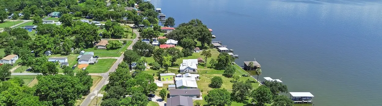 Aerial view of a charming neighborhood showcasing well-maintained houses and lush trees