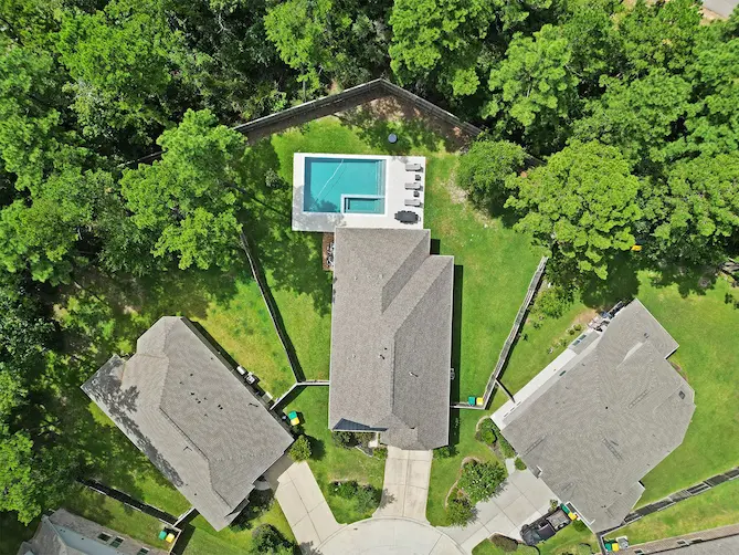 Aerial view of a vibrant neighborhood featuring a sparkling pool