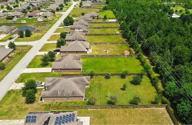 Aerial view showcasing a charming neighborhood with well-maintained houses and lush trees, ideal for family living.