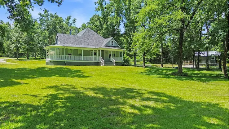 A charming home surrounded by a spacious yard and mature trees