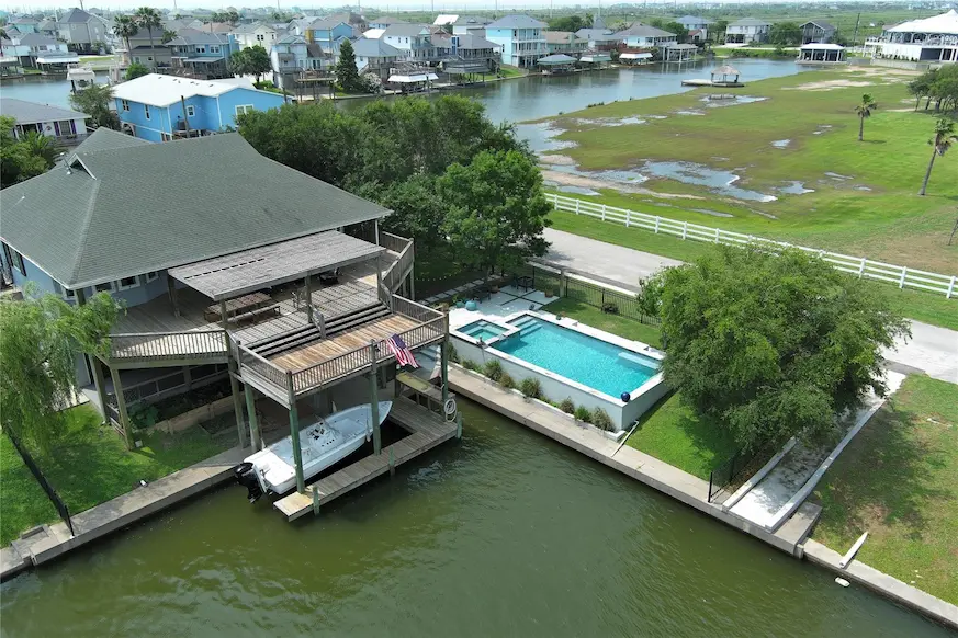 A charming house with a dock and a boat moored in the water