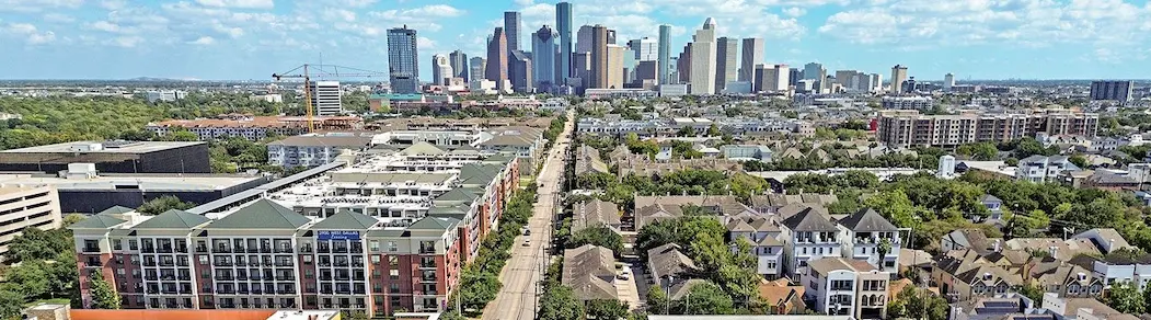 A city skyline featuring tall buildings and trees