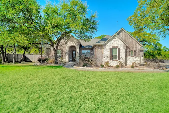 A charming country home surrounded by a spacious yard