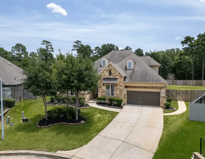 Large home featuring a spacious driveway and attached garage, ideal for convenient parking and access.