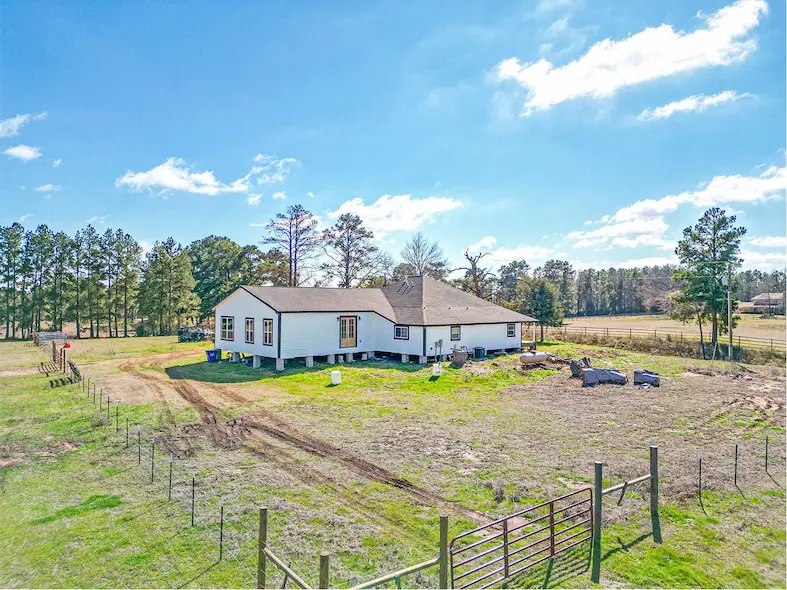 A spacious farm featuring a large, fenced yard, ideal for outdoor activities and pet-friendly living.