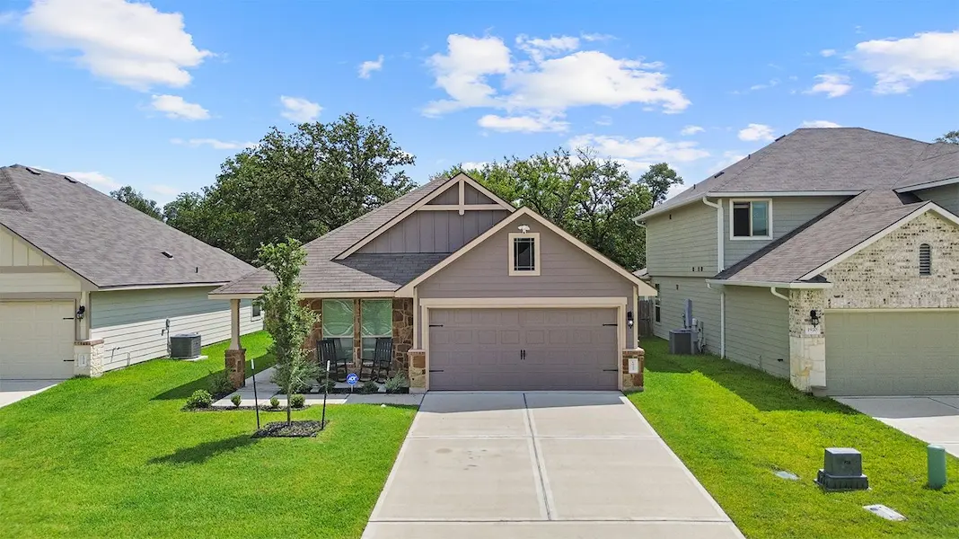A spacious home featuring garage and a wide driveway