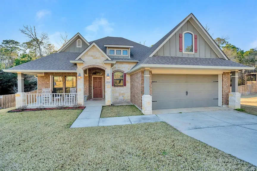 A spacious home featuring a large garage and an expansive yard