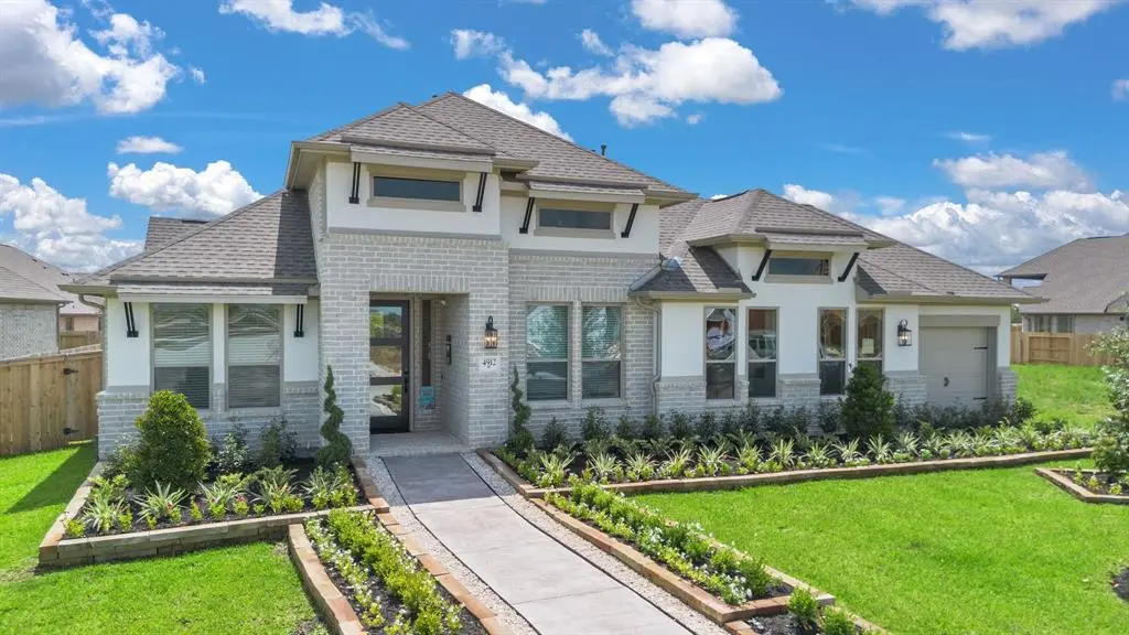 A spacious home with a large yard and well-maintained landscaping