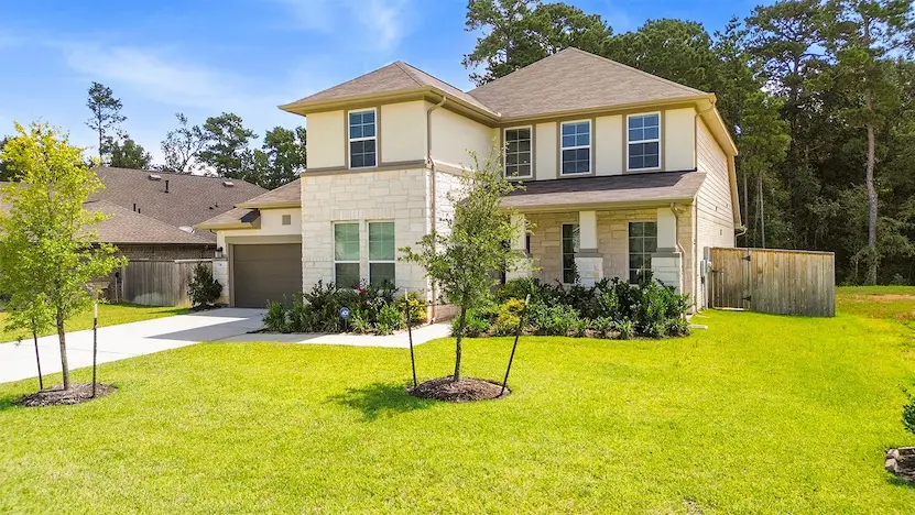 A spacious home surrounded by a large yard and mature trees