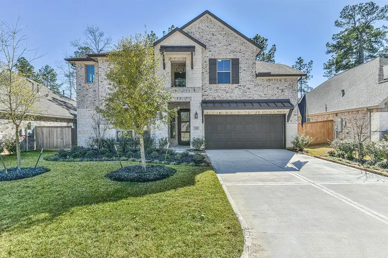 A charming home nestled in a wooded neighborhood, showcasing natural surroundings and inviting architecture.