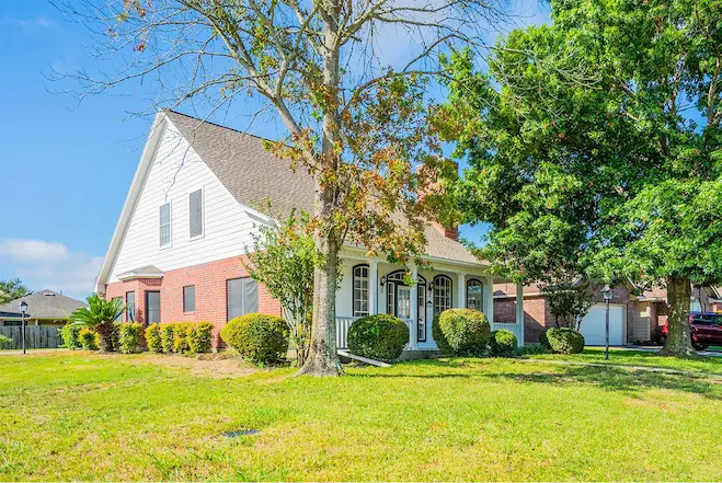 A charming home surrounded by a spacious yard and mature trees