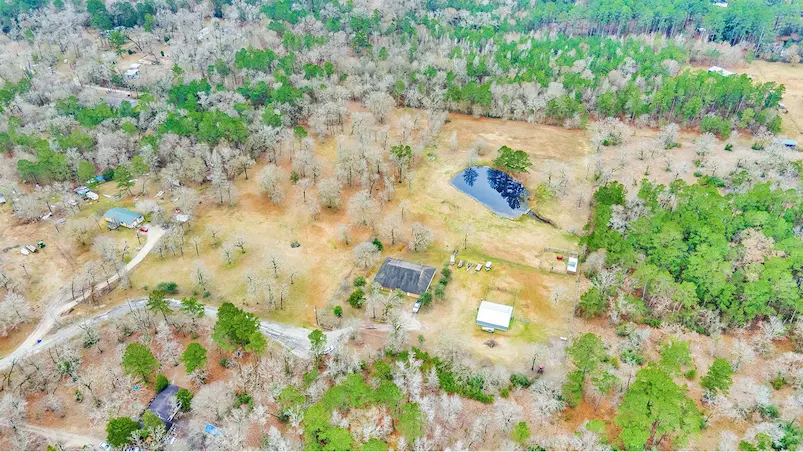 Aerial view showcasing a lush, tree-filled rural landscape