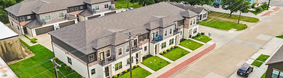 Aerial view of a neighborhood showcasing houses and parked cars