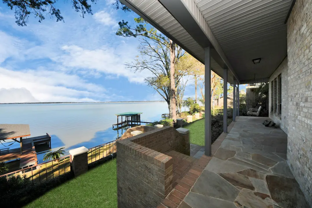 Inviting porch overlooking a calm lake, offering a serene atmosphere for leisure and outdoor gatherings.