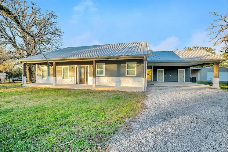 Spacious home featuring a large driveway and expansive garage, perfect for your vehicles and storage needs.