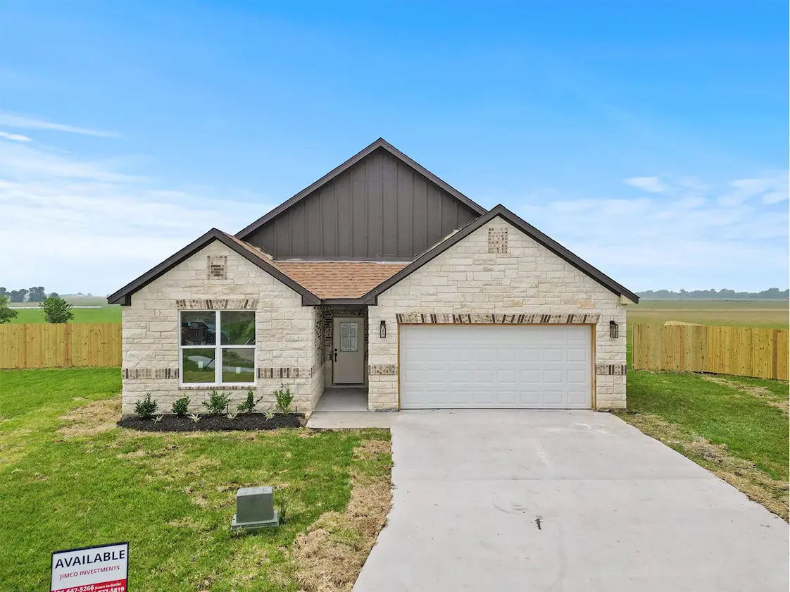 A spacious home featuring a large garage and a well-maintained fence, ideal for privacy and convenience.