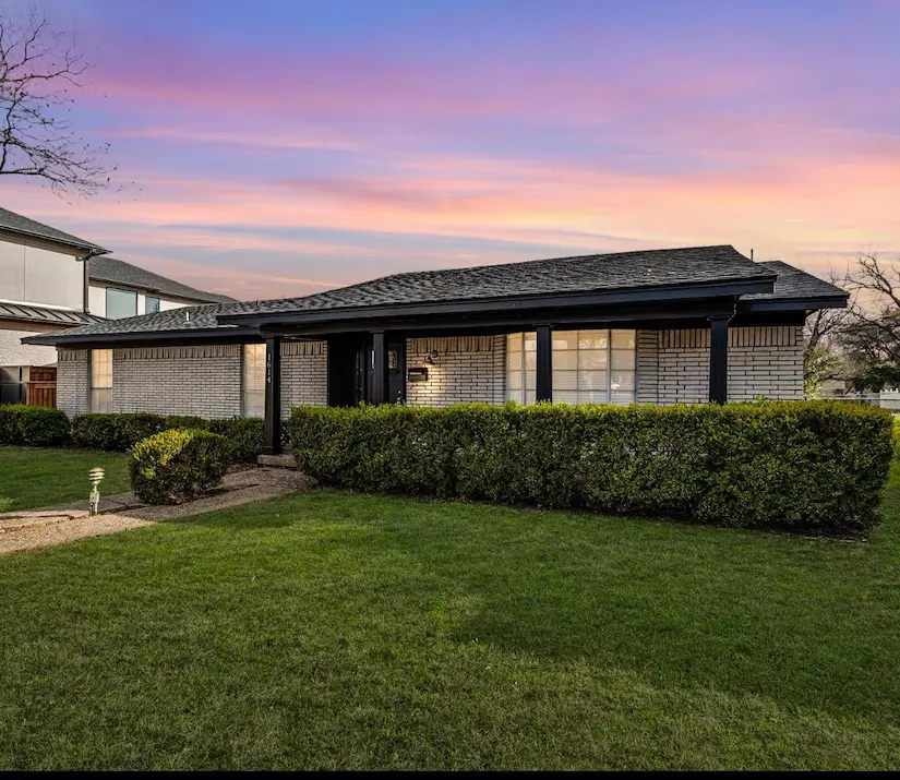a spacious home with a large yard and driveway