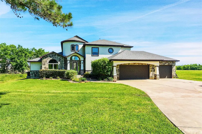 A spacious house featuring a driveway and garage