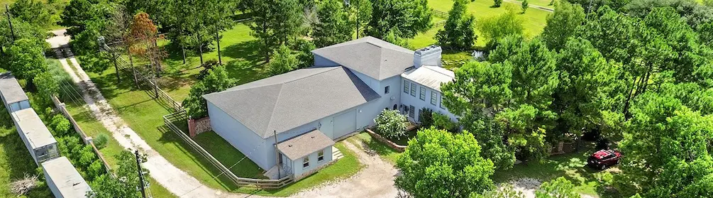 Aerial view of a charming home nestled among lush trees
