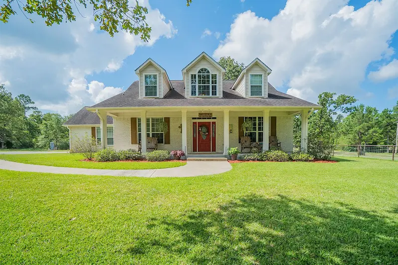 Spacious home featuring a large yard and a welcoming driveway