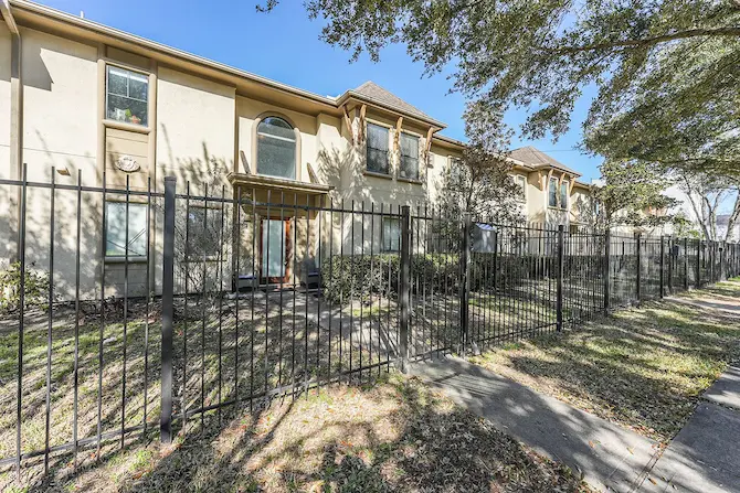 A fenced two-story apartment building