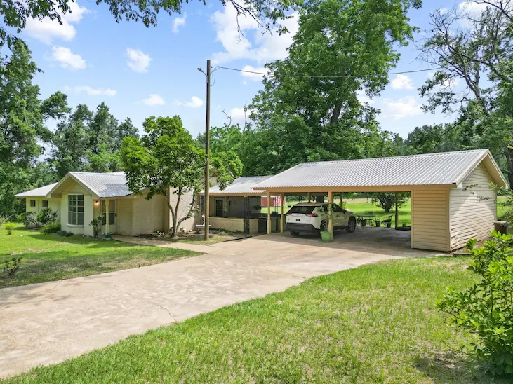A charming home featuring a spacious driveway and an attached garage