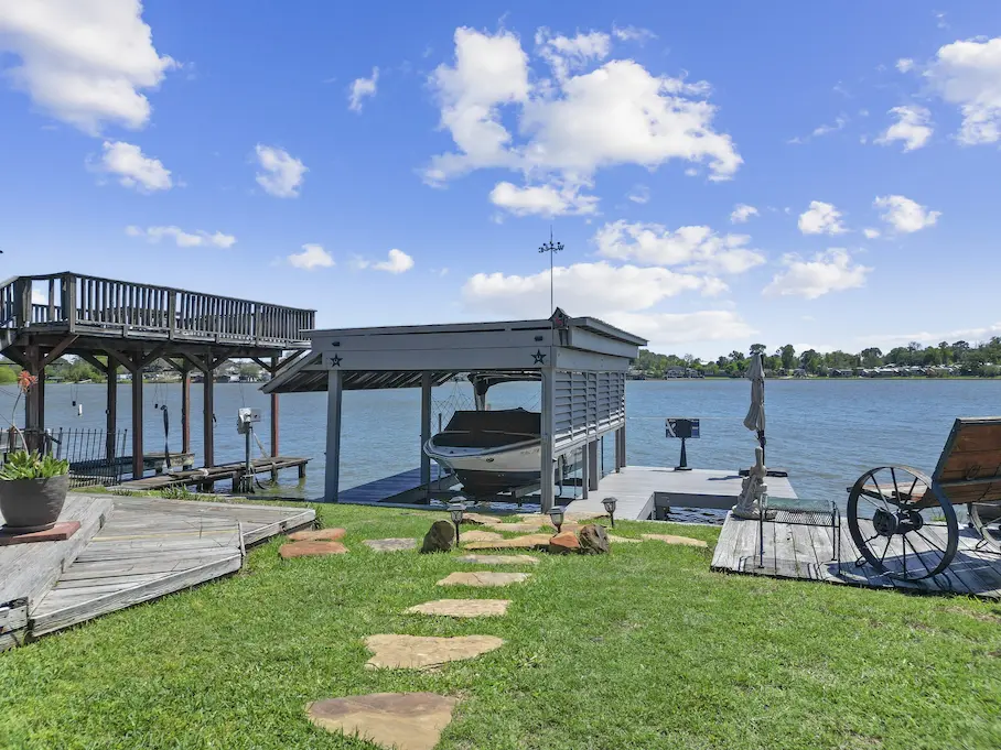 A serene boat dock beside a charming house, showcasing waterfront living