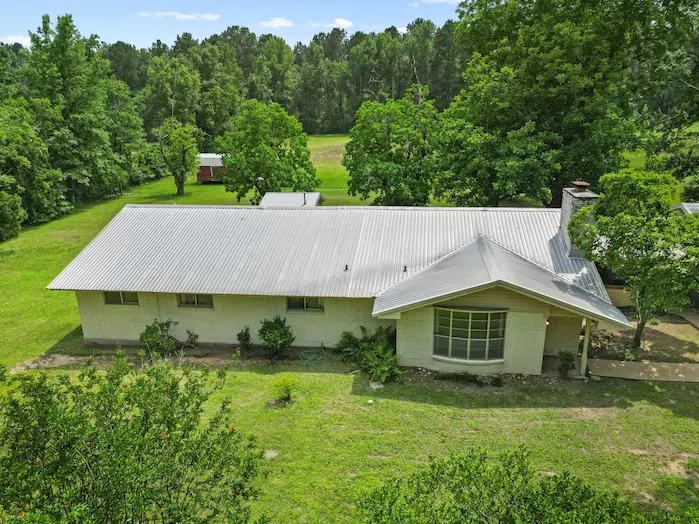 A charming home surrounded by a spacious yard and mature trees
