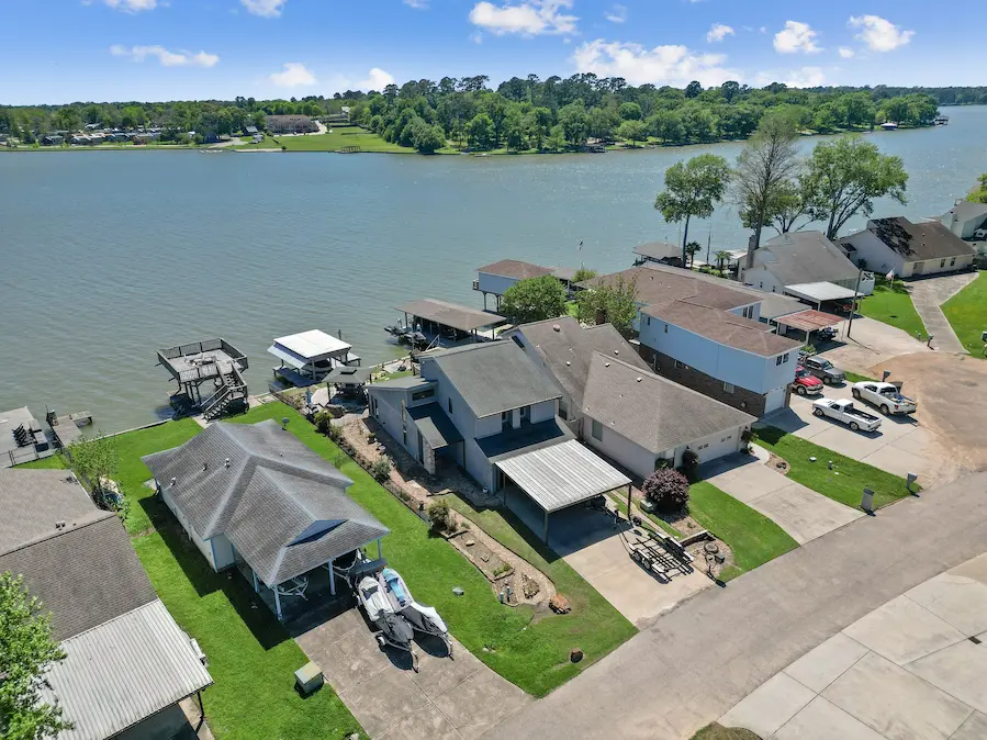 A charming house with a boat dock and a boat gently floating in the water
