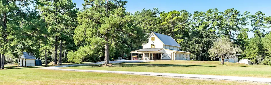 A charming church surrounded by a vast field, ideal for a serene farm or ranch property setting.