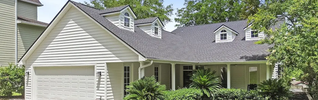 A charming house featuring a spacious garage and a well-maintained driveway