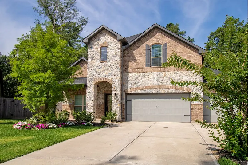 A spacious home featuring a large garage and well-maintained landscaping, ideal for comfortable living and entertaining.