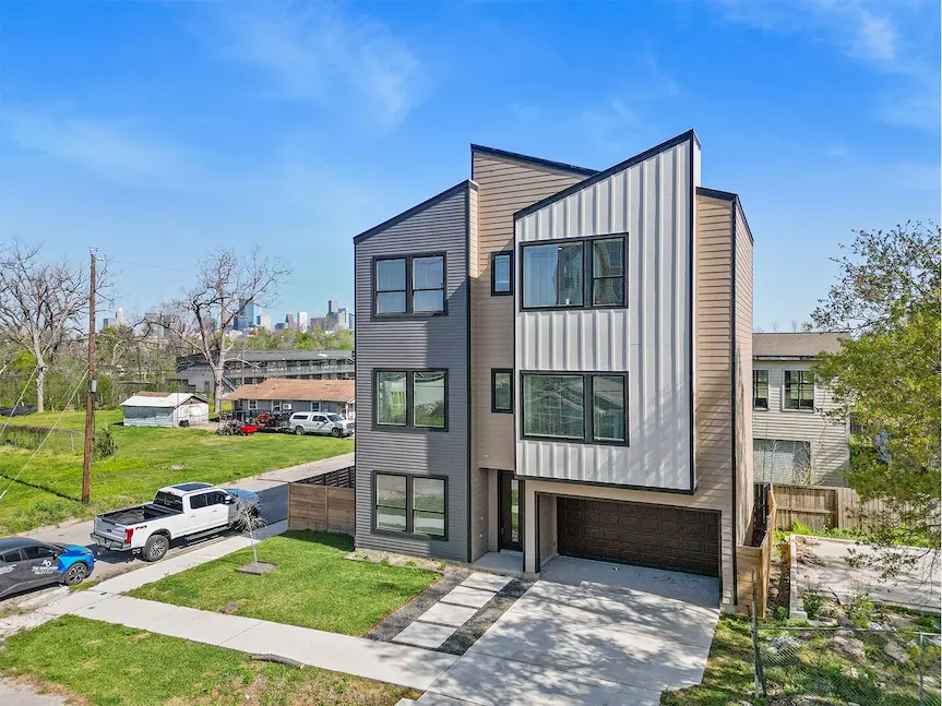 A modern home featuring two garages and a driveway