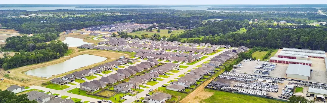 Aerial view of a lush residential neighborhood featuring numerous trees and spacious lots ready for new homes.