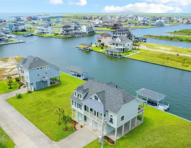 A scenic view of a large body of water surrounded by charming houses along the shoreline